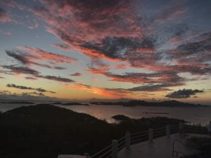 A view of the ocean from above at sunset.