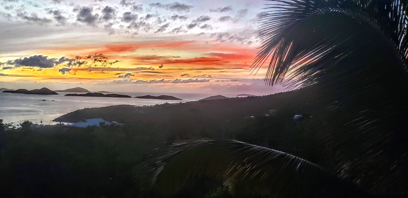 A view of the ocean from above at sunset.