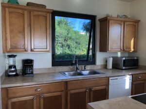 A kitchen with wooden cabinets and a sink